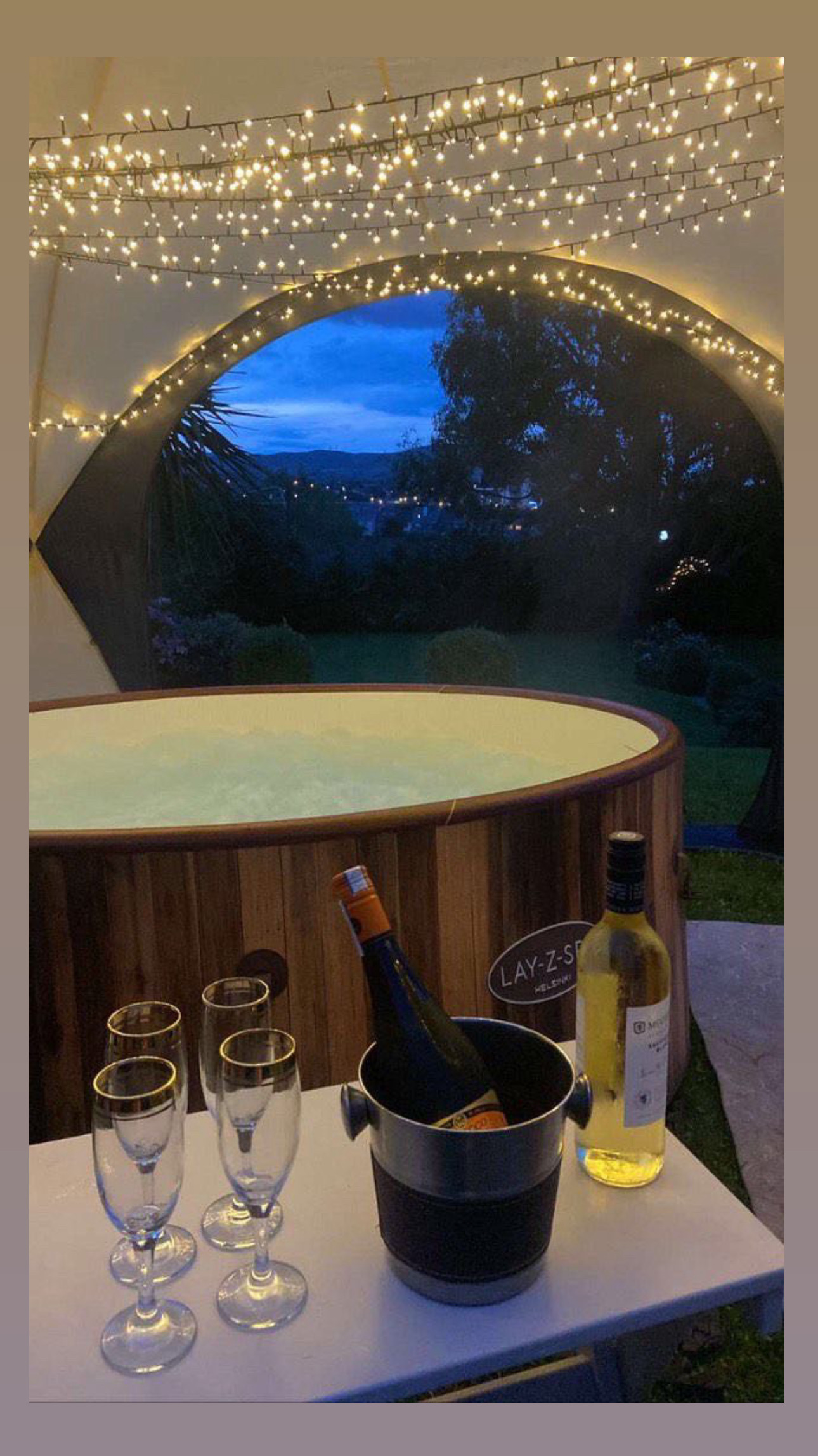 Luxury hot tub under fairy lights with champagne — romantic evening hire